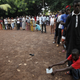 People wait for the opening of the polling office at Hamdalaye neighborhood during a presidential election in Conakry.